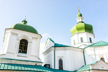 Fototapeta na wymiar Kyiv, Ukraine Mykola Prytyska orthodox green church historic exterior religion facade on sunny day in Kiev with cupola dome closeup
