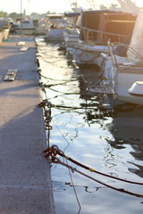 Small boats in a port during sunset. Selective focus.