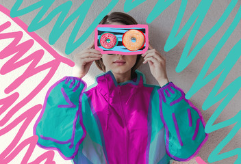 Young woman in 90s style clothes holding VHS cassette