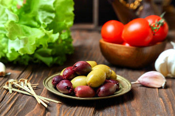 Olives in a bronze plate  on the kitchen table