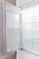 Open empty modern white kitchen refrigerator fridge inside interior vertical closeup of appliance
