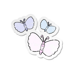 distressed sticker of a cartoon butterflies