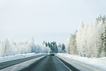 Fototapeta premium Landscape with car road at snowy winter Lapland