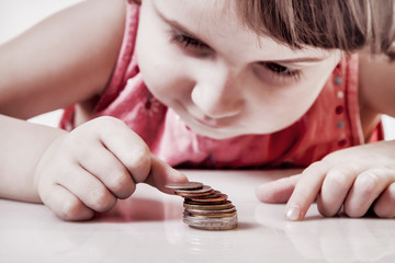 Best motivation is money. Humorous portrait of little business child with coints.