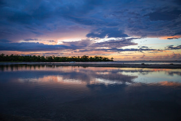 Bright and colorful sunset in Fiji after heavy rain with lots of reflections
