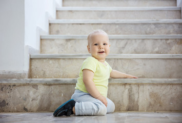 Happy baby girl at bottom of stairs outdoors