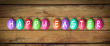 colored eggs with letters forming the word easter on wooden background