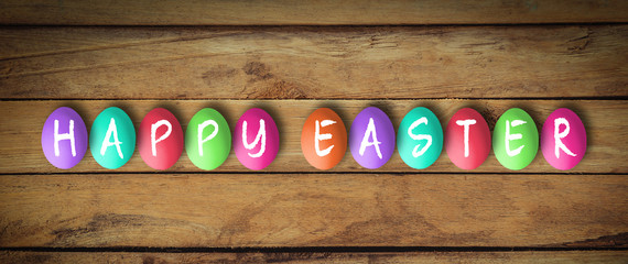 colored eggs with letters forming the word easter on wooden background