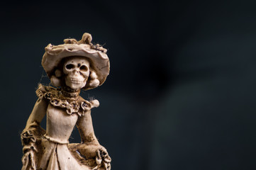 Hand carved Mexican female skeleton wedding cake topper.