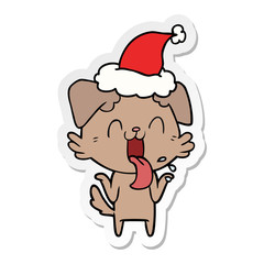 sticker cartoon of a panting dog shrugging shoulders wearing santa hat