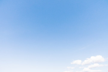 Naklejka na ściany i meble Clear blue sky background with white clouds.