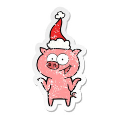 distressed sticker cartoon of a pig with no worries wearing santa hat
