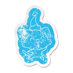 happy little dog cartoon distressed sticker of a wearing santa hat