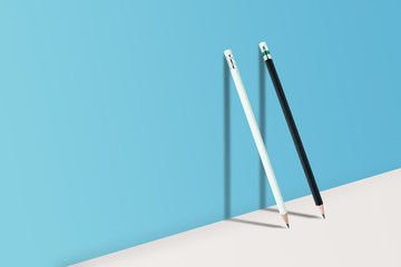 Business Creative and Idea Concept : Black and White pencils standing on white floor and shadow on blue wall.