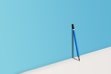 Business Creative and Idea Concept : Blue pencil standing on white floor with shadow shading on blue wall.