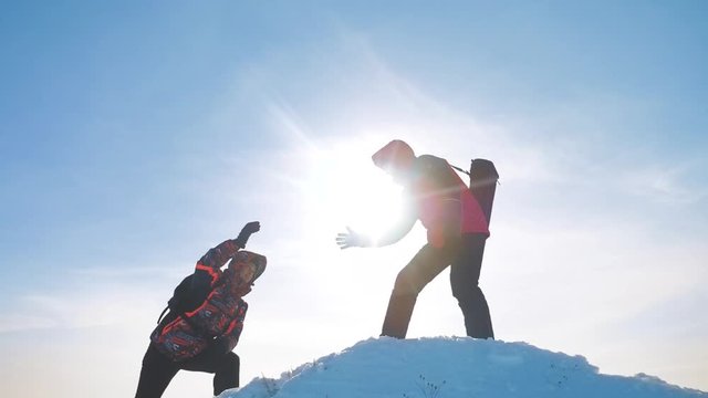 teamwork business concept victory help hands arm slow motion video. team group tourist hikers gives a helping hand. success win winter reached the top of the mountain. tourists climbers climb to the