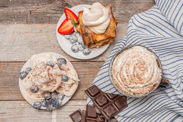 Healthy breakfast. Coffee and delicious pancakes, with fresh berries on wooden table