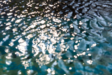 Naklejka na ściany i meble Blurred ripple water in swimming pool, Abstract bokeh background, Sun reflection
