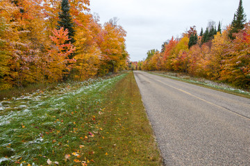 Diminishing Two Lane Road. Rural asphalt highway through an autumn forest in the Hiawatha National Forest at the Upper Peninsula of Michigan.