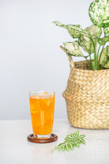 Orange juice soda mix on marble tile background.
