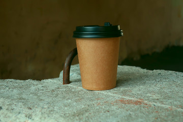 a cup of freshly brewed coffee on a concrete slab