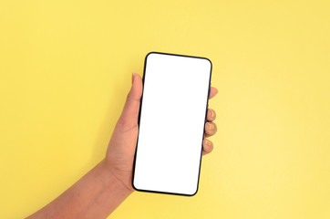 Human hand holding smartphone with white screen background.