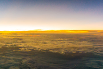 Fototapeta na wymiar Colorful sunrise sky with cloud above view from airplane