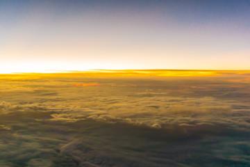 Fototapeta na wymiar Colorful sunrise sky with cloud above view from airplane