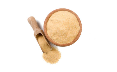 dried milled ground garlic in wooden bowl and scoop isolated on white background. top view. Spices and food ingredients.