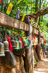 Old bell hangs on steel rail in The stone with the footprint of Lord Buddha at Khitchakut mountain It is a major tourist attraction Chanthaburi, Thailand.