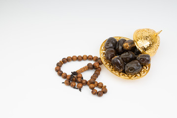 Dates and Rosary on white background with selective focus and crop fragment. Ramadan, Religion and Copy space concept. Black and White