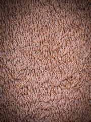 beige fabric terry cloth towel texture with vignette. background, bedroom.