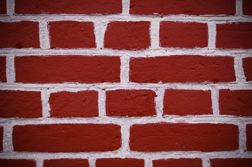 wall of red bricks with white paint texture, background. vignette, exterior