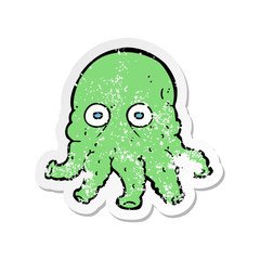retro distressed sticker of a cartoon alien squid face