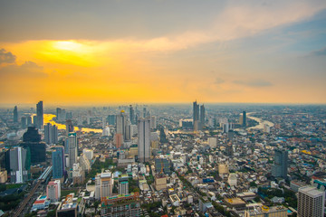 Sunset skyline over Bangkok city central business downtown with some partial rainy clouds.