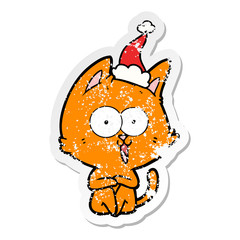 funny distressed sticker cartoon of a cat wearing santa hat