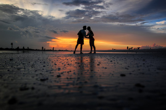 Silhouettes of a couple kissing on a beach at Honeymoon Island State Park near Clearwater, Florida