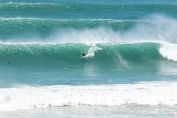 man surfer catching big wave from top of the hill at Kirra Coolangatta Queensland Gold Coast Australia 
