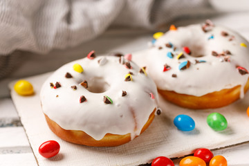 Cookery, baking and food concept - closeup. Donuts in white glaze.