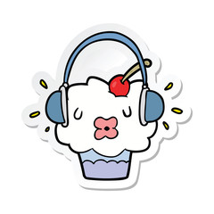 sticker of a cartoon cupcake listening to music