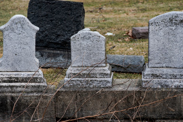 Weathered Gravestones in graveyard at old  cemetery.