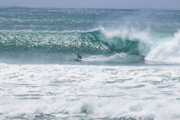 man surfer catching big wave from Kirra beach Coolangatta Queensland Gold Coast Australia cyclone swell