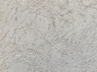 Rough light gray concrete wall texture. Wrinkle pattern intentionally after plaster.