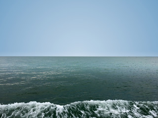 Beautiful calm sea wave under clear sky background