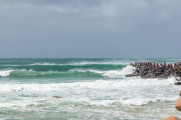 Fototapeta na wymiar Cyclone Oma swell hitting Kirra beach Coolangatta Gold Coast Australia tube barrel waves many people to see the waves