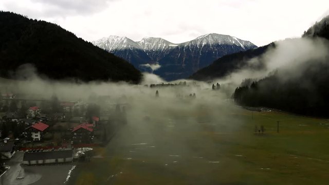 Landing into the fog in the mountains. 4K