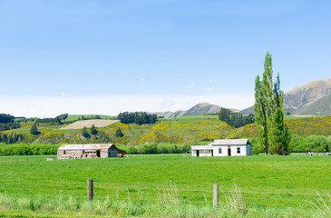 Rural land with fields and hills and old buildings,