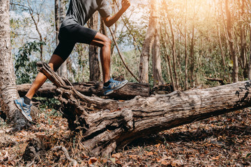 Image of Athlete trail running, runner running on hill.