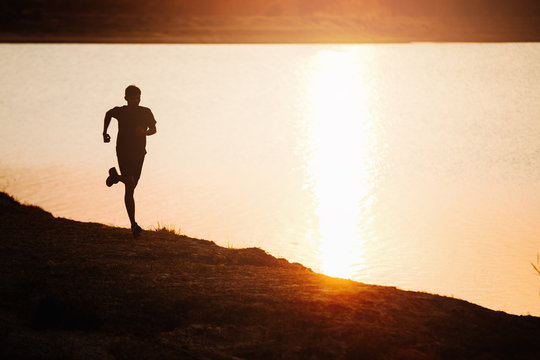 young fitness man running, athlete run at sunset time,healthy lifestyle sports concept.