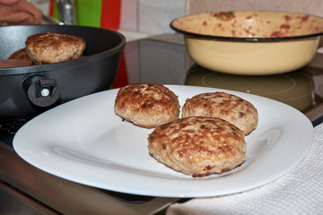 fried finished meat patties on a white plate standing on a table on a white towel. homemade fresh hearty wholesome food. cook cooks food at home. dinner.